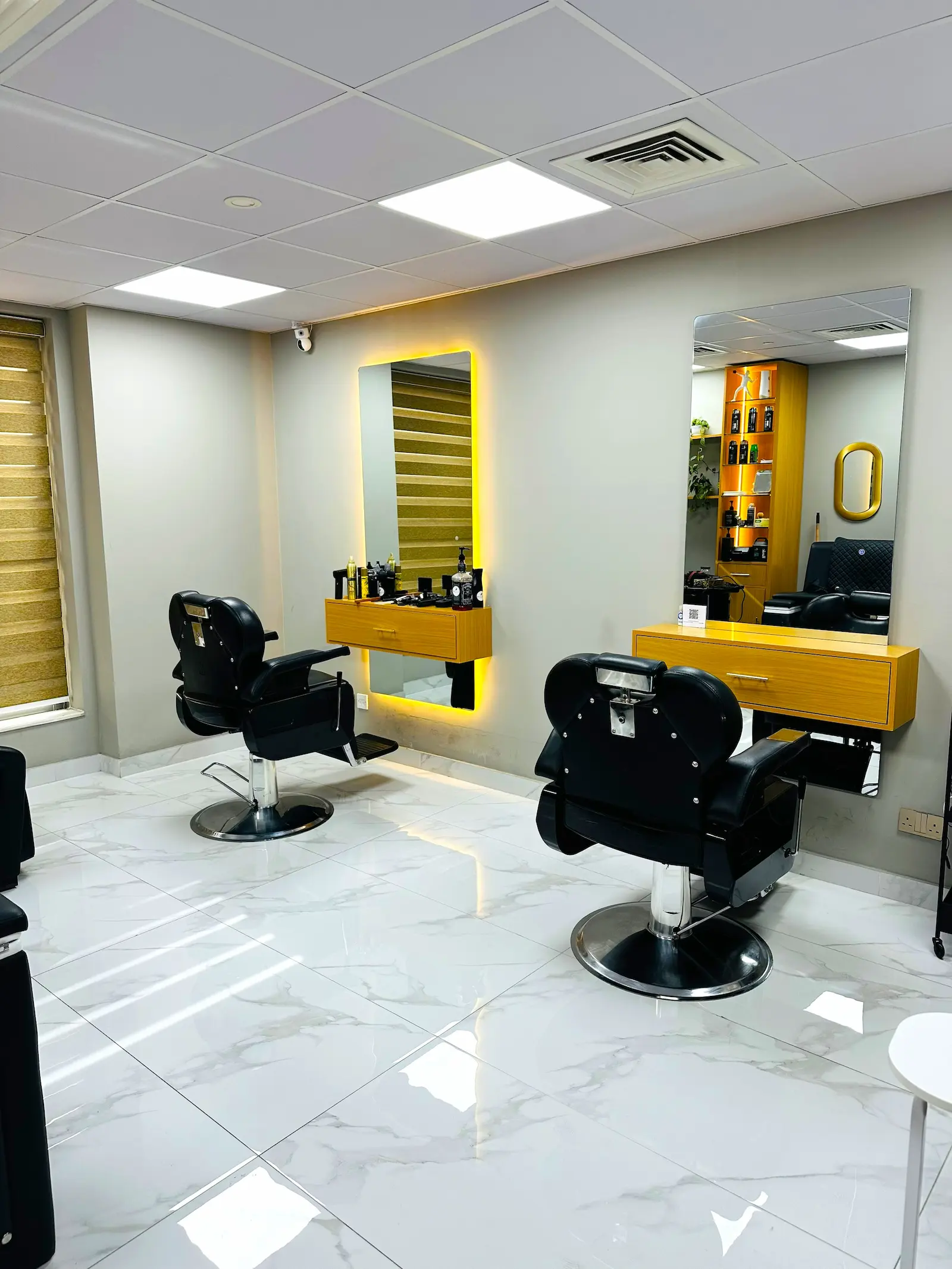 modern barber shop interior with chairs at Kings Afro Barbershop in JVC Dubai