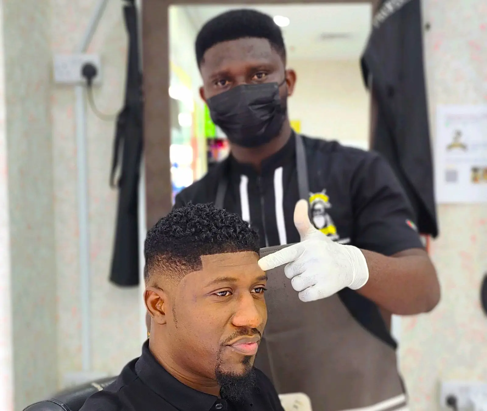 barber giving clean fade haircut to client at Kings Afro Barbershop in JVC Dubai