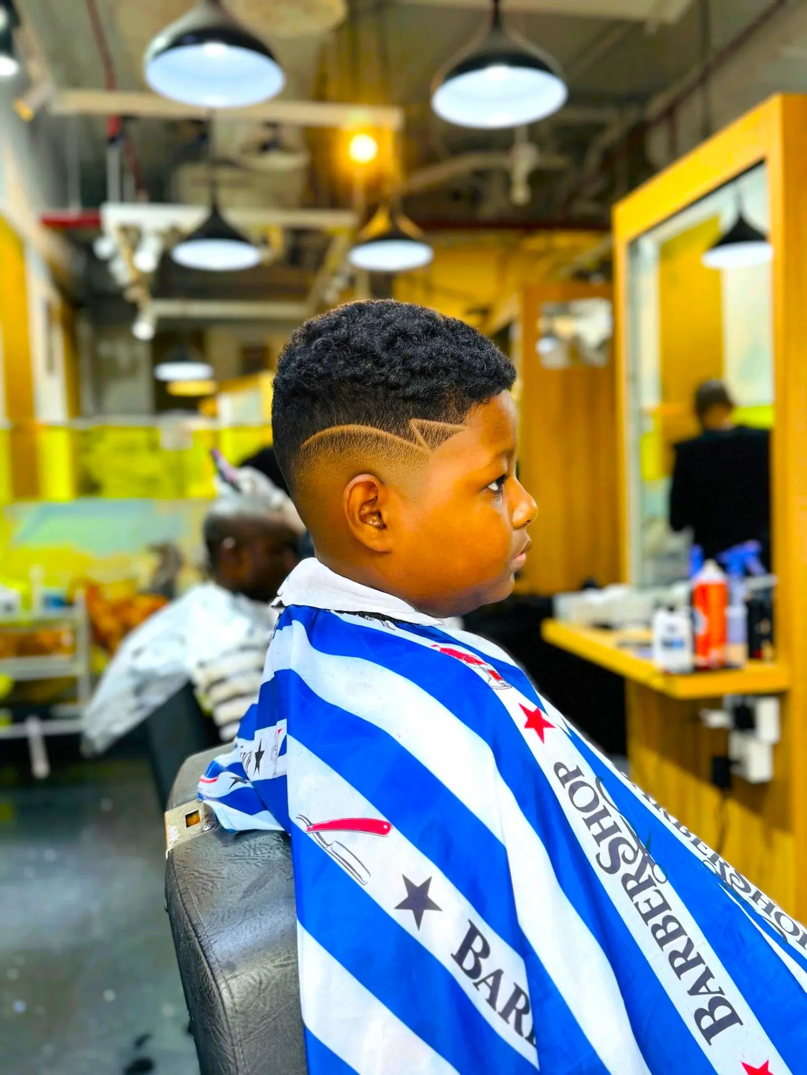 kids fade haircut with clean design line at Kings Afro Barbershop in JVC Dubai