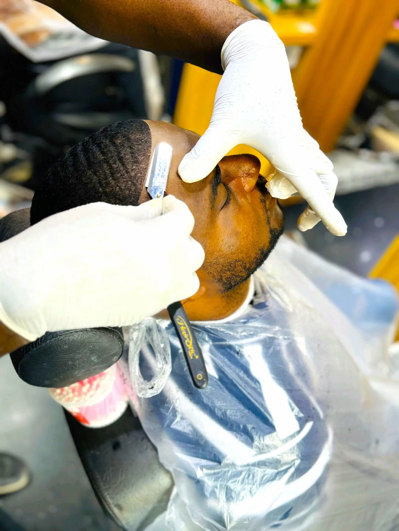 barber trimming beard with straight razor and precise lineup at Kings Afro Barbershop in JVC Dubai