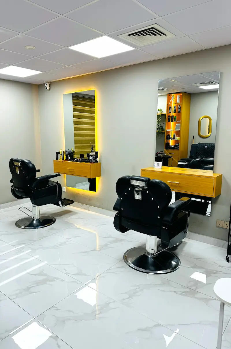 modern barber chairs and styling stations interior at Kings Afro Barbershop in JVC Dubai