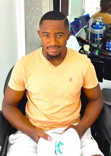 client with fresh haircut sitting in barber chair at Kings Afro Barbershop in JVC Dubai